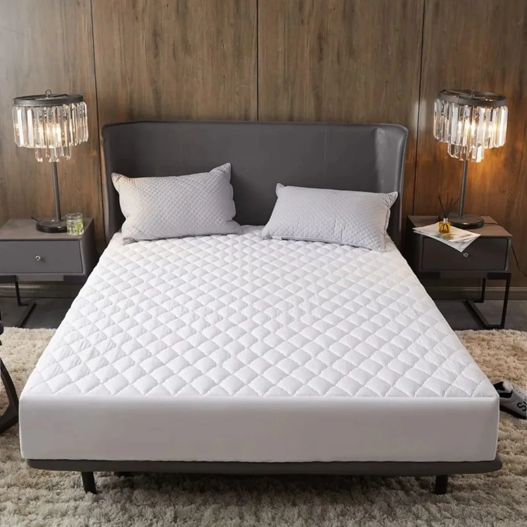 White quilted fitted mattress protector on a 6x6 bed
